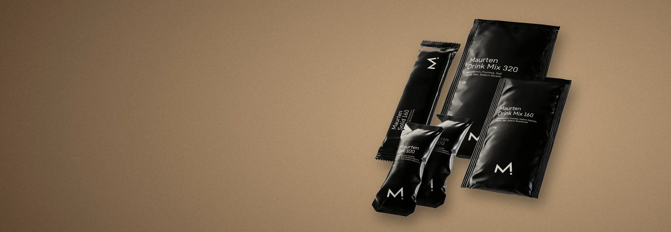 Maurten gels and drink mix sachets on a warm sand-coloured background