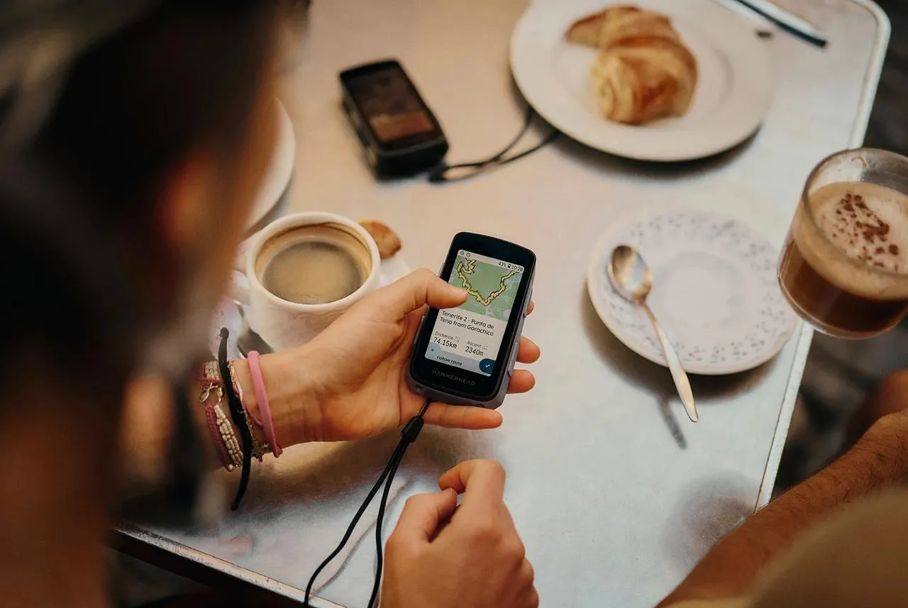Rider checking a route on the Hammerhead Karoo at a café table