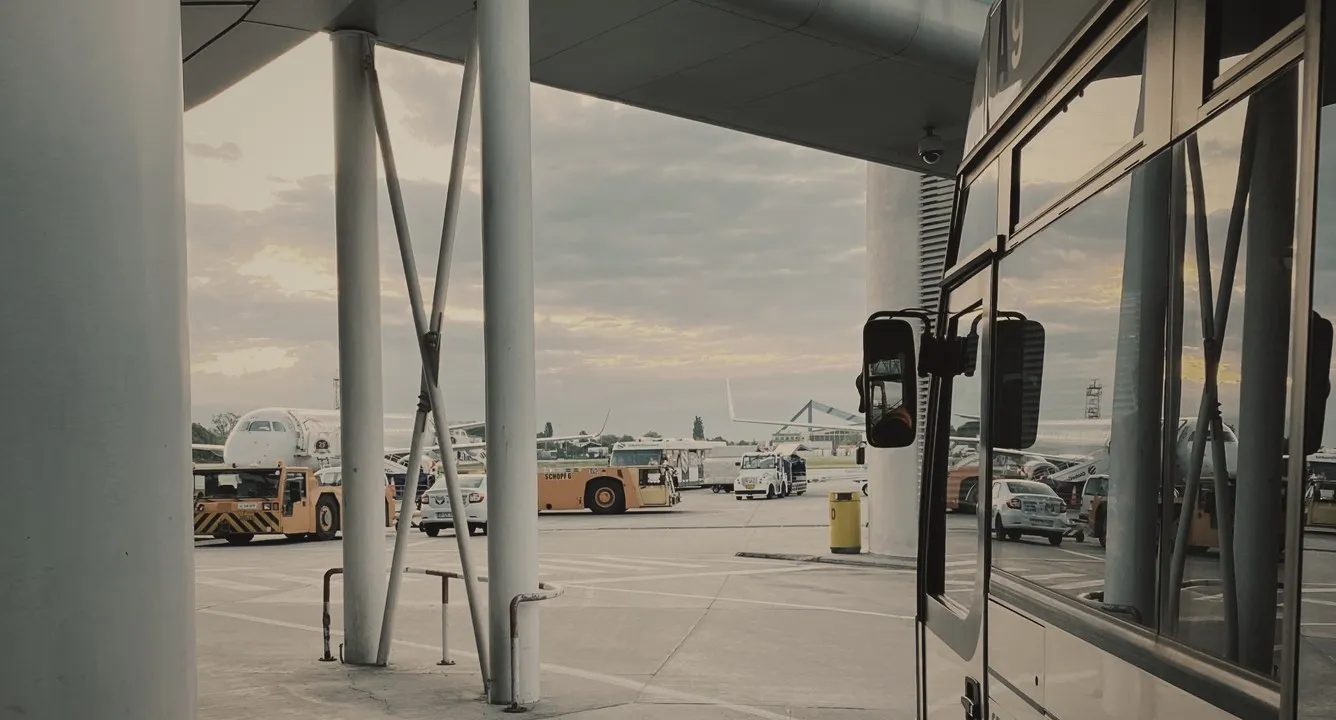 Airport shuttle bus parked at a terminal kerb