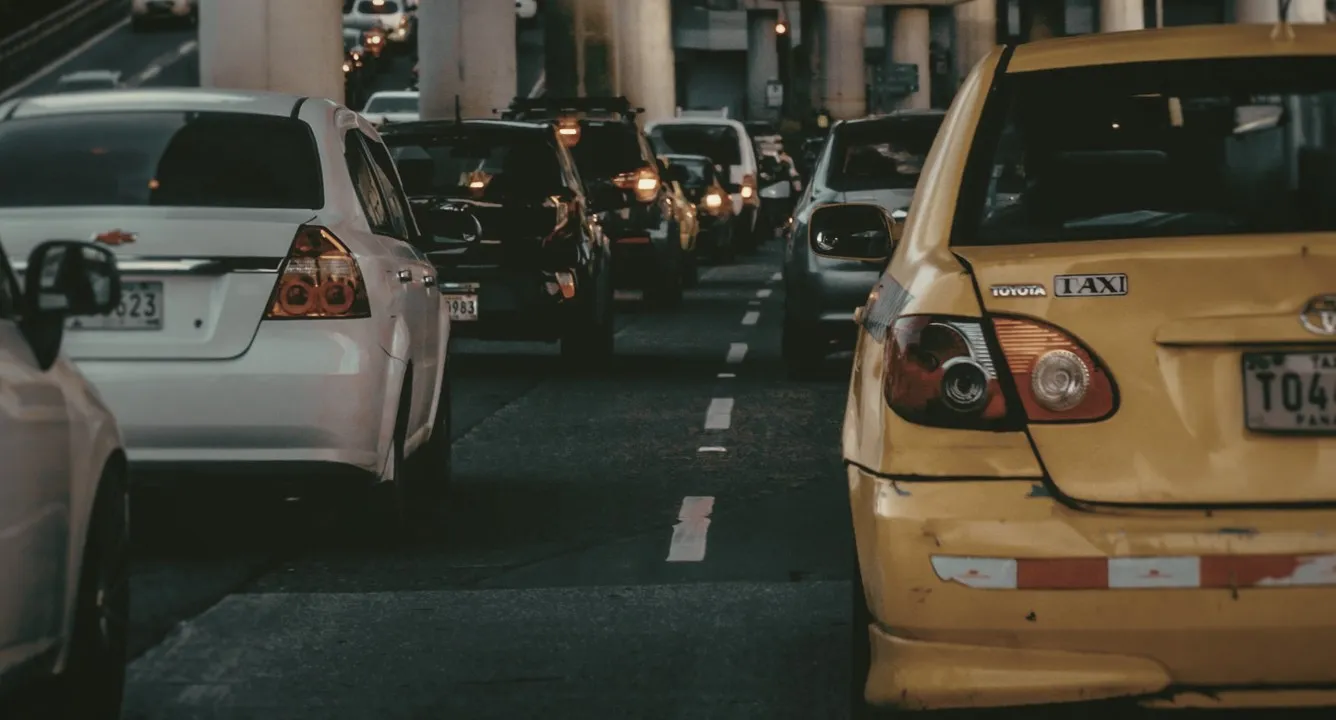 Cars and a yellow taxi in Metro Manila traffic