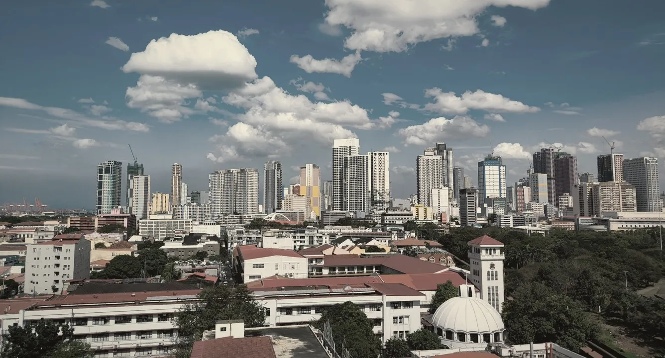 Manila city skyline under a blue sky