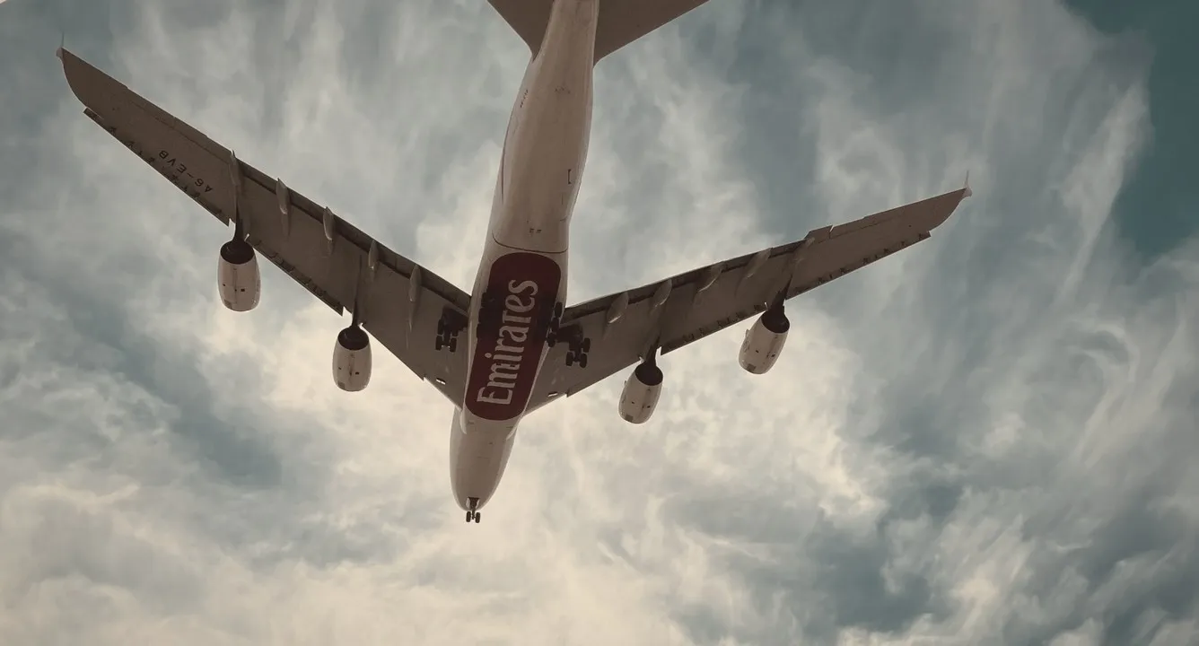Underside of a long-haul airliner against a cloudy sky